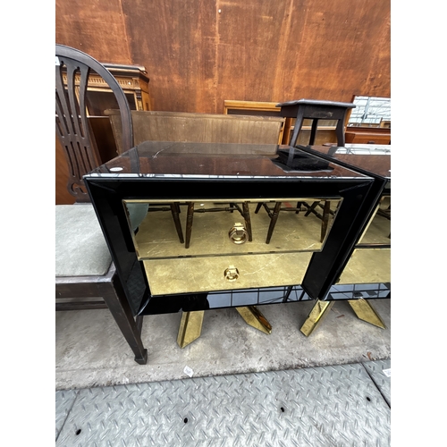 2612 - A PAIR OF BLACK GLASS BEDSIDE CHESTS EACH WITH TWO GOLD COLOURED DRAWERS AND MIRRORED LEGS