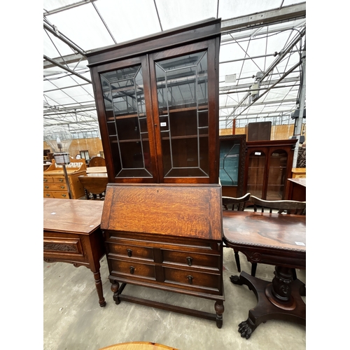 2634 - AN EARLY 20TH CENTURY OAK BUREAU BOOKCASE WITH GLAZED AND LEADED UPPER PORTION, 35
