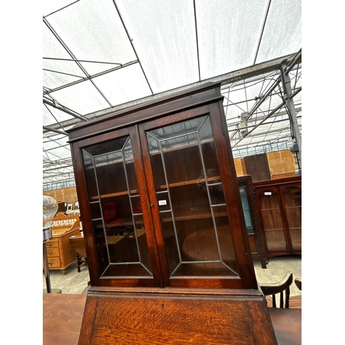 2634 - AN EARLY 20TH CENTURY OAK BUREAU BOOKCASE WITH GLAZED AND LEADED UPPER PORTION, 35