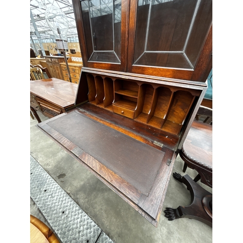 2634 - AN EARLY 20TH CENTURY OAK BUREAU BOOKCASE WITH GLAZED AND LEADED UPPER PORTION, 35