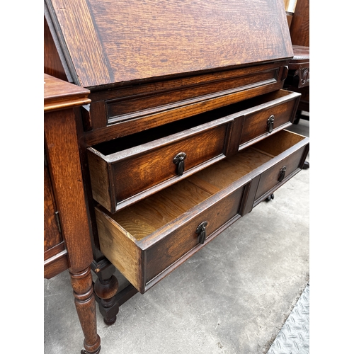 2634 - AN EARLY 20TH CENTURY OAK BUREAU BOOKCASE WITH GLAZED AND LEADED UPPER PORTION, 35