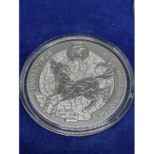 323 - A BOXED SET OF FOUR SILVER PROOF COINS 2018 YEAR OF THE DOG