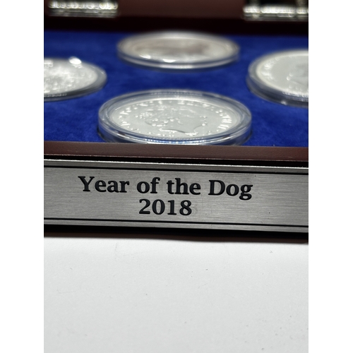 323 - A BOXED SET OF FOUR SILVER PROOF COINS 2018 YEAR OF THE DOG