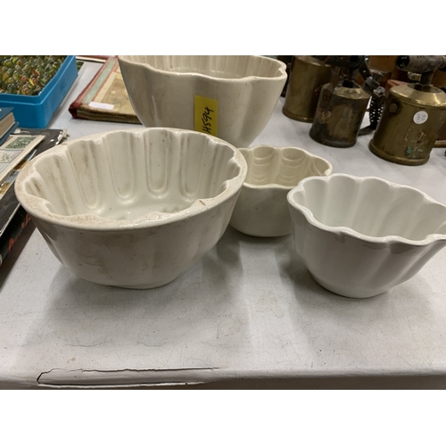 210 - A COLLECTION OF VINTAGE CERAMIC JELLY MOULDS