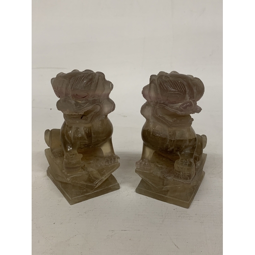 371 - A CHINESE ROCK CRYSTAL POSSIBLY SMOKY QUARTZ CARVED INTO A  PAIR OF FOO DOGS/GUARDIAN LIONS - 12 CM