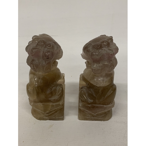 371 - A CHINESE ROCK CRYSTAL POSSIBLY SMOKY QUARTZ CARVED INTO A  PAIR OF FOO DOGS/GUARDIAN LIONS - 12 CM