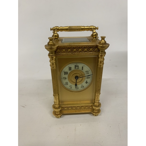79 - A FRENCH GILT BRASS CARRIAGE CLOCK WITH REEDED COLUMNS, ORNATE GILT FRETWORK PANELS, ENAMEL CHAPTER ... 