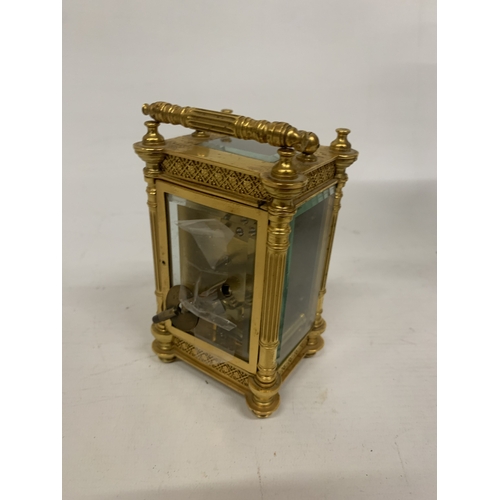 79 - A FRENCH GILT BRASS CARRIAGE CLOCK WITH REEDED COLUMNS, ORNATE GILT FRETWORK PANELS, ENAMEL CHAPTER ... 