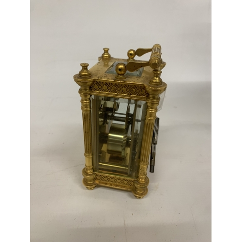 79 - A FRENCH GILT BRASS CARRIAGE CLOCK WITH REEDED COLUMNS, ORNATE GILT FRETWORK PANELS, ENAMEL CHAPTER ... 