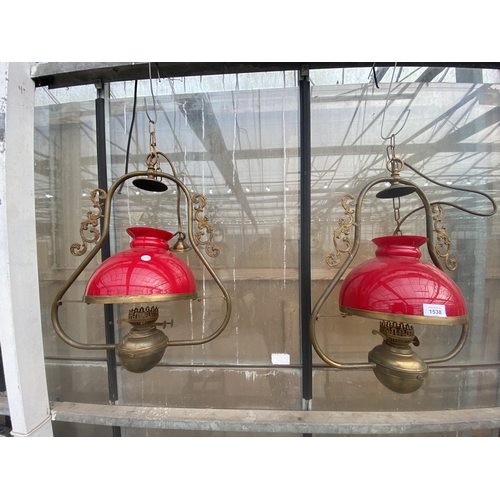 1538 - A PAIR OF VINTAGE BRASS CEILING LIGHT FITTINGS WITH RED GLASS SHADES