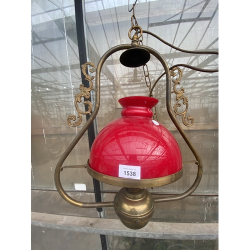 1538 - A PAIR OF VINTAGE BRASS CEILING LIGHT FITTINGS WITH RED GLASS SHADES