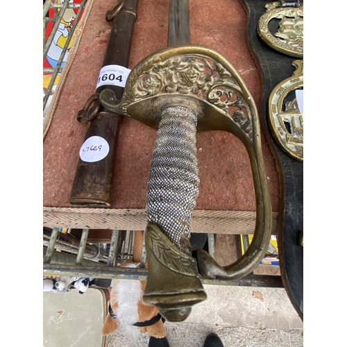 1604 - A SWORD AND SCABBARD WITH BRASS HANDLE