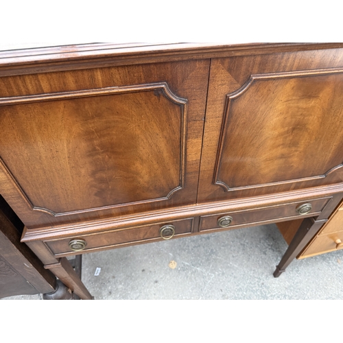 2661 - A REPRODUX MAHOGANY COCKTAIL CABINET WITH LIFT UP TOP AND TWO DRAWERS ON TAPERING LEGS, 35
