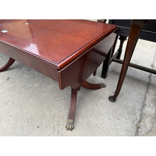 2671 - A MAHOGANY AND CROSSBANDED DROP LEAF COFFEE TABLE ON BRASS CLAW FEET