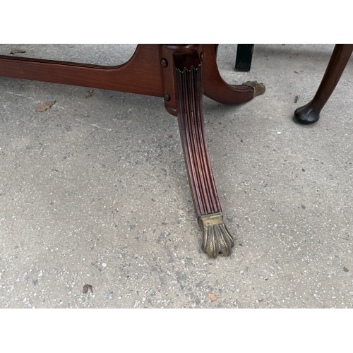 2671 - A MAHOGANY AND CROSSBANDED DROP LEAF COFFEE TABLE ON BRASS CLAW FEET