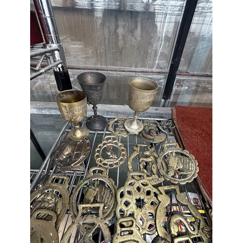 1650 - THREE BRASS GOBLETS AND AN ASSORTMENT OF HORSE BRASSES