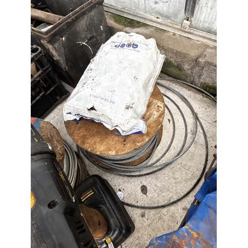1694 - A SITEMASTER CORDLESS DRILL, A ROLL OF WIRE ROPE AND A ROLL OF ELECTRIC CABLE