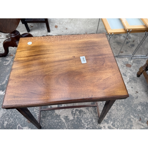 2745 - AN EDWARDIAN MAHOGANY FOLD OVER GAMES TABLE