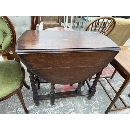 2746 - AN EARLY 20TH CENTURY OVAL OAK GATE LEG TABLE ON BARLEY TWIST LEGS, 40