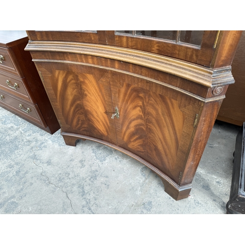 2763 - A MAHOGANY INVERTED BOW FRONTED CORNER CABINET WITH GLAZED UPPER PORTION AND DENTIL CORNICE, 36