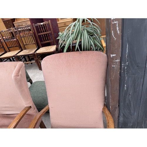 2773 - A MID 20TH CENTURY UPHOLSTERED ROCKING CHAIR AND SIMILAR FIRESIDE CHAIR