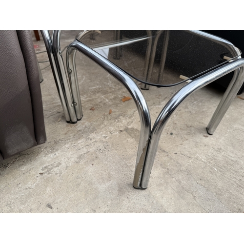 2802 - A TUBULAR CHROME AND GLASS NEST OF THRE TABLES