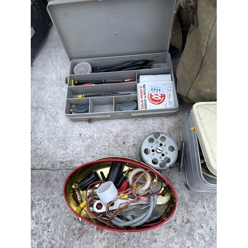 1711 - A WICKER FISHING TACKLE BASKET WITH AN ASSORTMENT OF FISHING TACKLE TO INCLUDE REELS AND FLOATS ETC