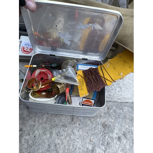 1711 - A WICKER FISHING TACKLE BASKET WITH AN ASSORTMENT OF FISHING TACKLE TO INCLUDE REELS AND FLOATS ETC