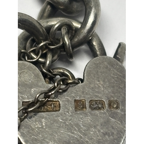 549 - A HEAVY SILVER WRIST CHAIN WITH A HALLMARKED BIRMINGHAM SILVER HEART LOCK GROSS WEIGHT 23.2 GRAMS
