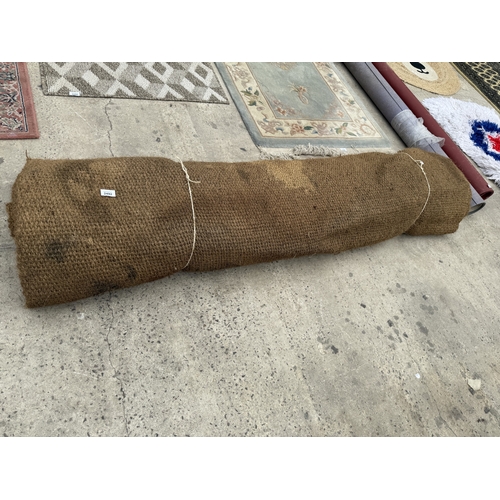 A LARGE HESSIAN RUG
