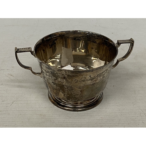 3 - A HALLMARKED 1935 LONDON SILVER TWIN-HANDLED CUP WITH AN ENGRAVED DESIGN ON THE BODY, MAKER FINNIGAN... 