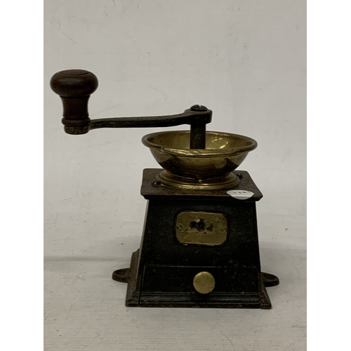 22 - A VINTAGE STEEL AND BRASS COFFEE GRINDER WITH INDISTINCT NAME PLAQUE