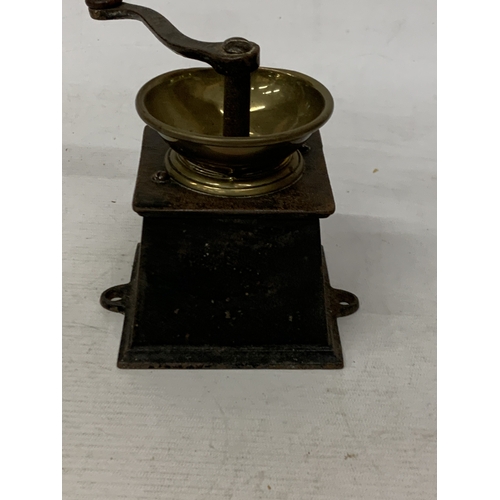 22 - A VINTAGE STEEL AND BRASS COFFEE GRINDER WITH INDISTINCT NAME PLAQUE