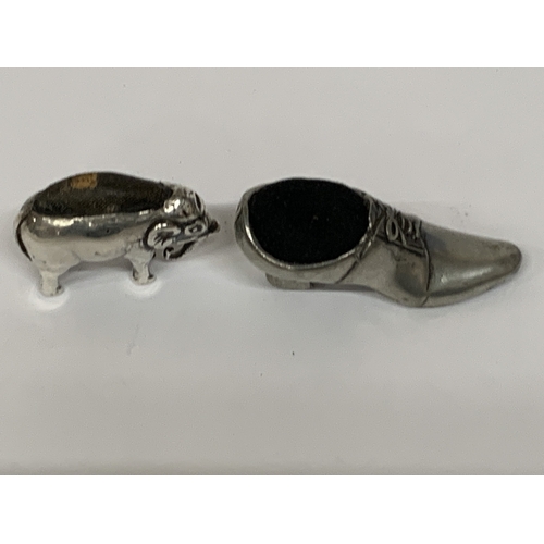 23 - TWO PINCUSHIONS TO INCLUDE A HALLMARKED SILVER ELEPHANT (HALLMARKS VERY RUBBED) AND A SHOE