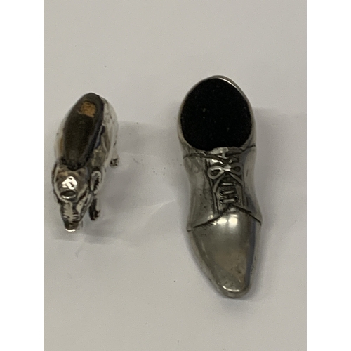 23 - TWO PINCUSHIONS TO INCLUDE A HALLMARKED SILVER ELEPHANT (HALLMARKS VERY RUBBED) AND A SHOE