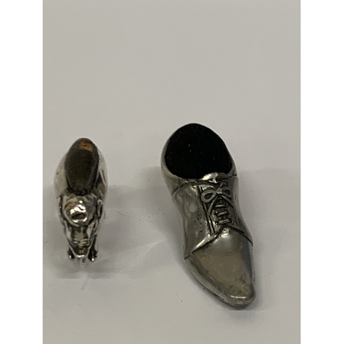 23 - TWO PINCUSHIONS TO INCLUDE A HALLMARKED SILVER ELEPHANT (HALLMARKS VERY RUBBED) AND A SHOE