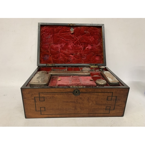 37 - A VINTAGE MAHOGANY VANITY CASE CONTAINING A FITTED SECTION OF JARS AND BOTTLES, SOME WITH SILVER HAL... 