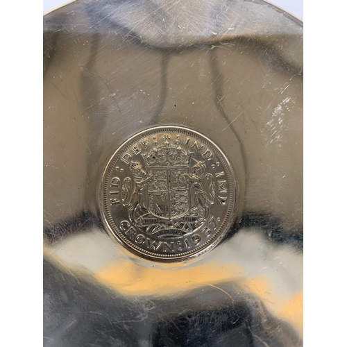46 - A HALLMARKED LONDON SILVER DISH WITH A CROWN SET INTO THE CENTER. THE DATE OF THE CROWN IS 1937 GROS... 