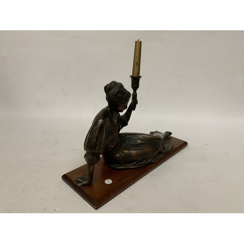 10 - A LARGE ART NOUVEAU FIGURE OF A RECLING LADY CANDLESTICK ON AN OAK BASE, HEIGHT 18CM, WIDTH 45CM