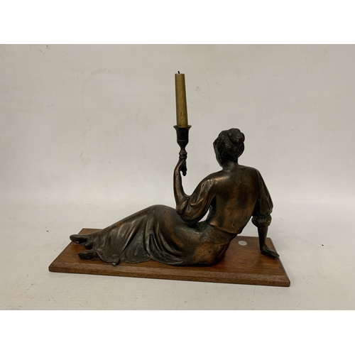 10 - A LARGE ART NOUVEAU FIGURE OF A RECLING LADY CANDLESTICK ON AN OAK BASE, HEIGHT 18CM, WIDTH 45CM