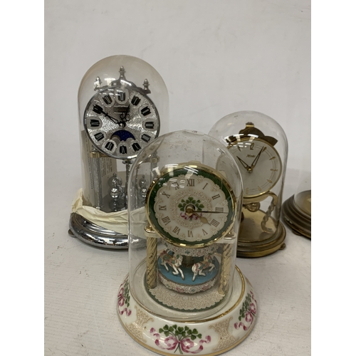 57 - FIVE ANNIVERSARY CLOCKS UNDER GLASS AND PLASTIC DOMES