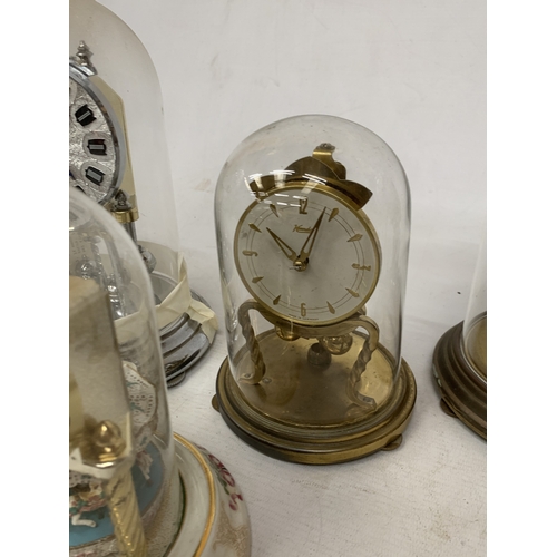 57 - FIVE ANNIVERSARY CLOCKS UNDER GLASS AND PLASTIC DOMES