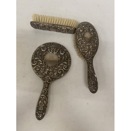 2 - A HALLMARKED BIRMINGHAM SILVER THREE PIECE BRUSH AND MIRROR SET