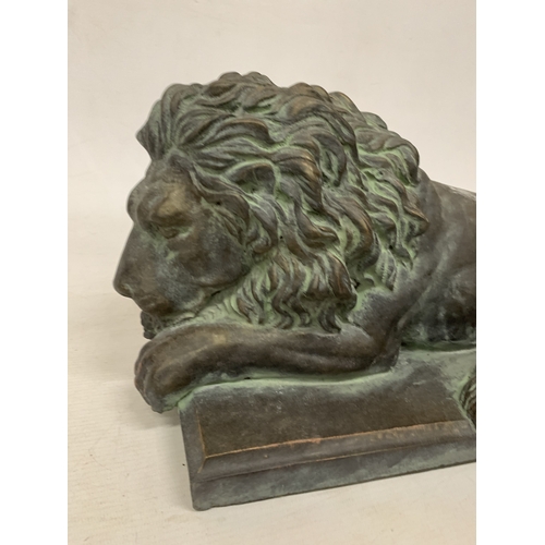 25 - A CARVED SERPENTINE MODEL OF A RECUMBENT SLEEPING LION - 40 CM (L)