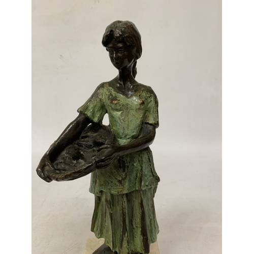29 - A BRONZE SCULPTURE OF A YOUNG DUTCH GIRL HOLDING A BASKET IN THE STYLE OF WORKS BY SWEDISH ARTIST RU... 