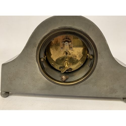 46 - AN ARTS & CRAFTS PEWTER HAMMERED NAPOLEON'S HAT SHAPED MANTEL CLOCK