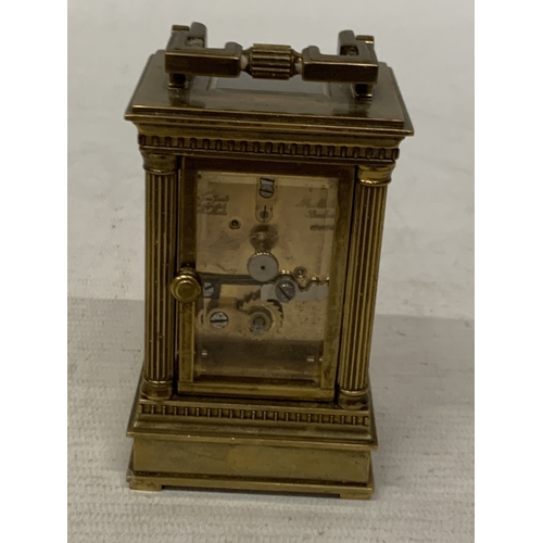 18 - A VINTAGE MATTHEW NORMAN LONDON MINIATURE CARRIAGE CLOCK IN A BRASS CORINTHIAN CASE WITH BEVELED GLA... 