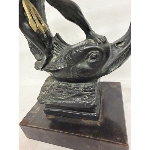 16 - A PATINATED BRONZE SCULPTURE OF NEPTUNE HOLDING A TRIDENT WHILST STANDING ON A STYLIZED SEA CREATURE... 