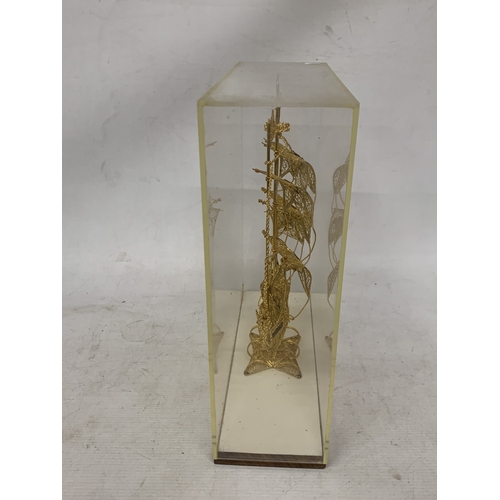 24 - A MODEL OF A GILT GALLEON WITH ENAMEL FLAGS IN A CASE, HEIGHT 33CM, WIDTH 30CM, DEPTH 10CM