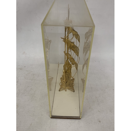 24 - A MODEL OF A GILT GALLEON WITH ENAMEL FLAGS IN A CASE, HEIGHT 33CM, WIDTH 30CM, DEPTH 10CM